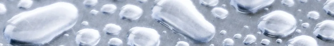 Close-up of water droplets on a smooth metallic surface, showcasing a fresh and clean aesthetic.