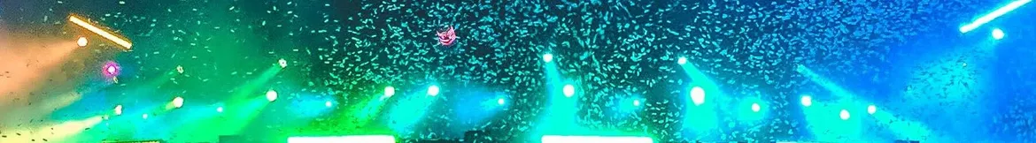 A vibrant concert scene with colourful stage lights and confetti filling the air, creating an electrifying atmosphere.